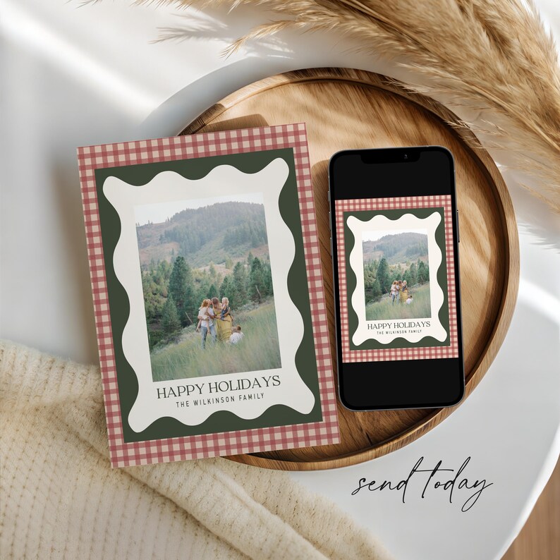 May include: A holiday card and a smartphone displaying the same image. The card features a family photo within a white wavy frame, set against a green border and a red and white checkered pattern. The text reads "HAPPY HOLIDAYS" and "THE WILKINSON FAMILY".