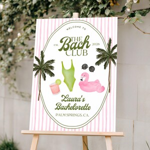May include: A welcome sign for a bachelorette party, featuring a pink and white striped background. The sign includes illustrations of a swimsuit, sunglasses, a flamingo float, and a cocktail. Text reads "Welcome to The Bach Club" and "Laura's Bachelorette, Palm Springs, CA."