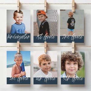 May include: Six photos of children, each labeled with a grade level from Kindergarten to 5th Grade. The photos are held by wooden clothespins on a string. Each photo features a child and the grade level written in a cursive font.