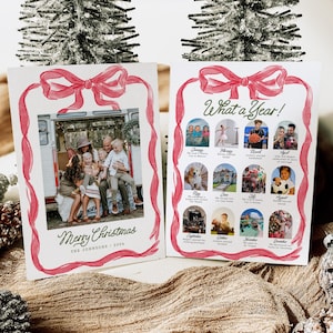 May include: A Christmas card featuring a family photo within a red ribbon frame. The card displays "Merry Christmas" and "What a Year!" with monthly photos and captions. A festive holiday greeting card.
