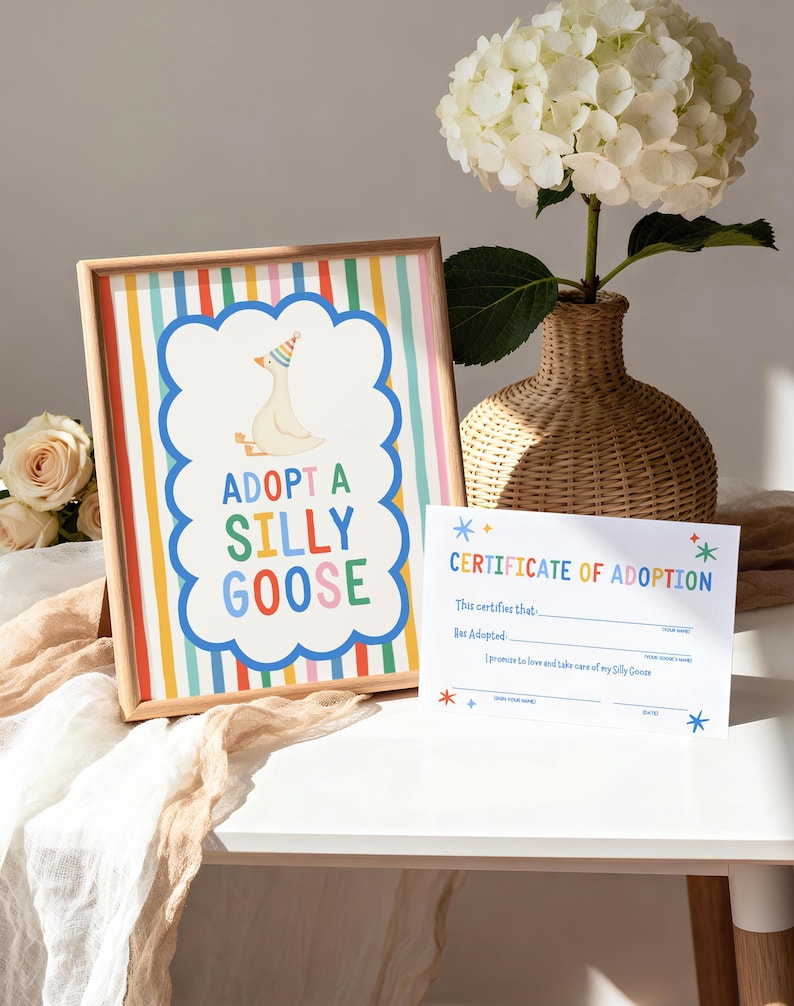 Puede incluir: Un letrero enmarcado con rayas verticales de arco&iacute;ris y un borde azul festoneado central que muestra un ganso con un sombrero de fiesta y el texto ADOPT A SILLY GOOSE, junto a un certificado de adopci&oacute;n de papel blanco con texto colorido.