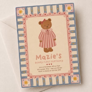 May include: A rectangular birthday invitation card featuring a brown teddy bear wearing a pink striped dress and bow. The card has a cream background, a pink scalloped border with hearts, and blue striped edges with yellow stars. Text reads: Mazie's BEARY FIRST BIRTHDAY, Join us November 8th at 4pm, 123 Juniper Way - San Luis Obispo, RSVP to Kenna at 123.456.7890.