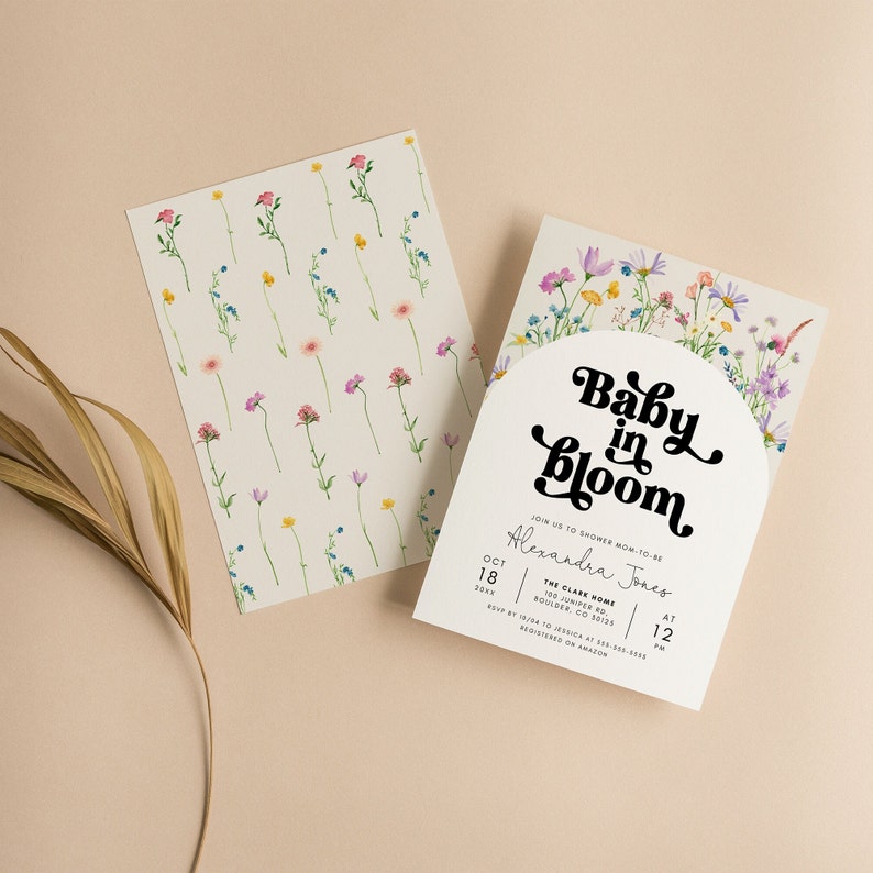 May include: A baby shower invitation with a floral design. The text reads "Baby in Bloom" and includes the name "Alexandra Jones". The invitation is for October 18th at 12 pm at The Clark Home, 100 Juniper Rd, Boulder, CO 50126.