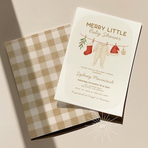 May include: A baby shower invitation with the text "MERRY LITTLE Baby Shower" and the name "Sydney Macintosh". The invitation features illustrations of baby clothes and a red stocking. The envelope has a tan and white checkered pattern.