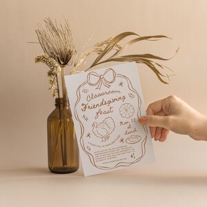 May include: A white card with a brown illustration of a turkey, a pie, and a pumpkin. The text on the card reads "Classroom Friendsgiving Feast Nov. 12 at Lunch A Feast Full of Fun & Gratitude We're excited for our classroom Friendsgiving Feast! Please RSVP by the sign-up link to let us know you can contribute to celebrate your turkey. We can't wait to appreciate your time! www.classroomgiving.com"