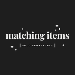 May include: Black background with white text that reads "matching items" in a serif font. Below the text is "| SOLD SEPARATELY |" in a sans-serif font. White starburst graphics are in each corner.