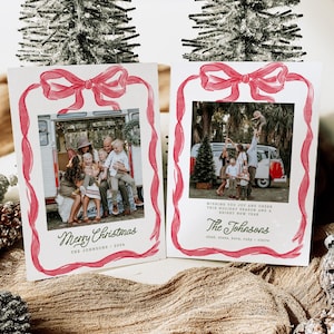 May include: Two Christmas cards featuring family photographs, framed with a red watercolour ribbon and bow design. One card reads "Merry Christmas" and "The Johnsons 2024." The other card says "Wishing you joy and cheer this holiday season and a bright new year."