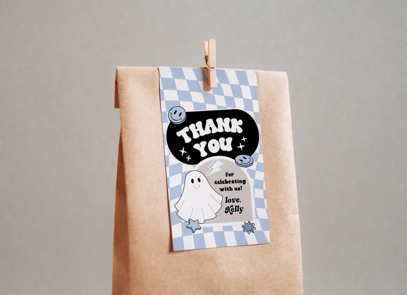 May include: A blue and white checkered thank you tag with a black speech bubble that says "Thank You". Inside the speech bubble is a white ghost with a lightning bolt and the text "for celebrating with us! love, Kelly".