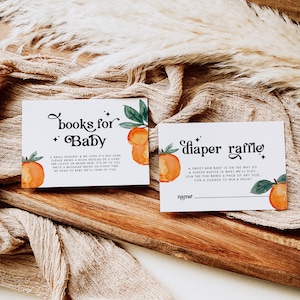 May include: Two cards with orange and green illustrations. The first card says "books for baby" and asks guests to bring a book instead of a card. The second card says "diaper raffle" and asks guests to bring a pack of diapers for a chance to win a prize.