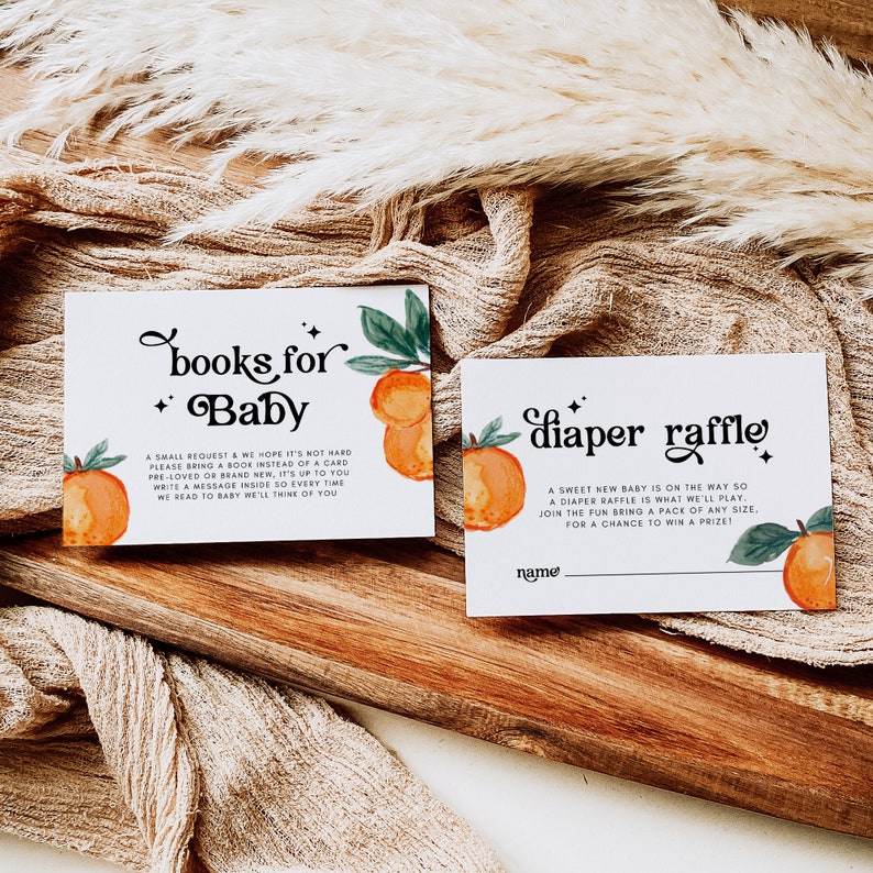 May include: Two cards with orange and green illustrations. The first card says "books for baby" and asks guests to bring a book instead of a card. The second card says "diaper raffle" and asks guests to bring a pack of diapers for a chance to win a prize.