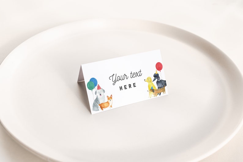 May include: White place card with a watercolor illustration of four dogs wearing party hats and holding balloons. The text "Your text HERE" is printed on the card.