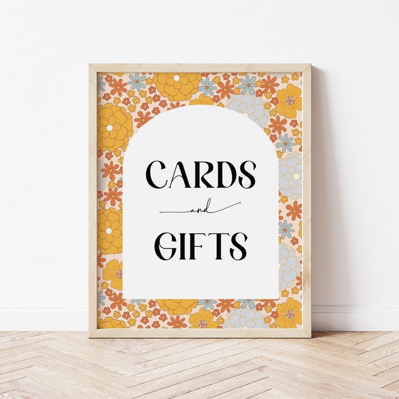 May include: A sign with a floral pattern border and a white archway. The text on the sign reads "CARDS and GIFTS".