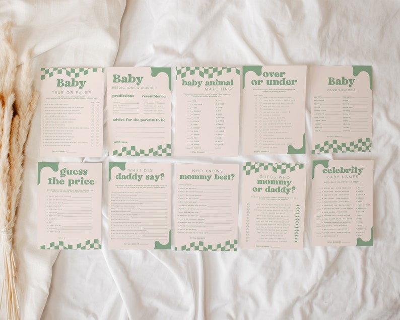 May include: A set of ten baby shower game cards in light pink with sage green text and checkerboard accents. Titles include Baby True or False, Predictions & Advice, Baby Animal Matching, Over or Under, Word Scramble, Guess the Price, What Did Daddy Say?, Who Knows Mommy Best?, Guess Who Mommy or Daddy?, and Celebrity Baby Names.