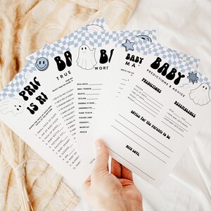 May include: A set of four baby shower game cards with a blue and white checkered background. The cards feature a ghost illustration and the text "Baby" in a retro font. The games include "Price is Right", "Baby Mama Word", "Predictions & Advice", and "Resemblance".