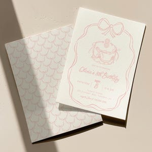 May include: Two-piece birthday invitation set. The invitation features a pink line drawing of a cake, bow, and text that reads "Olivia's 8th Birthday." The envelope has a pink scallop pattern.