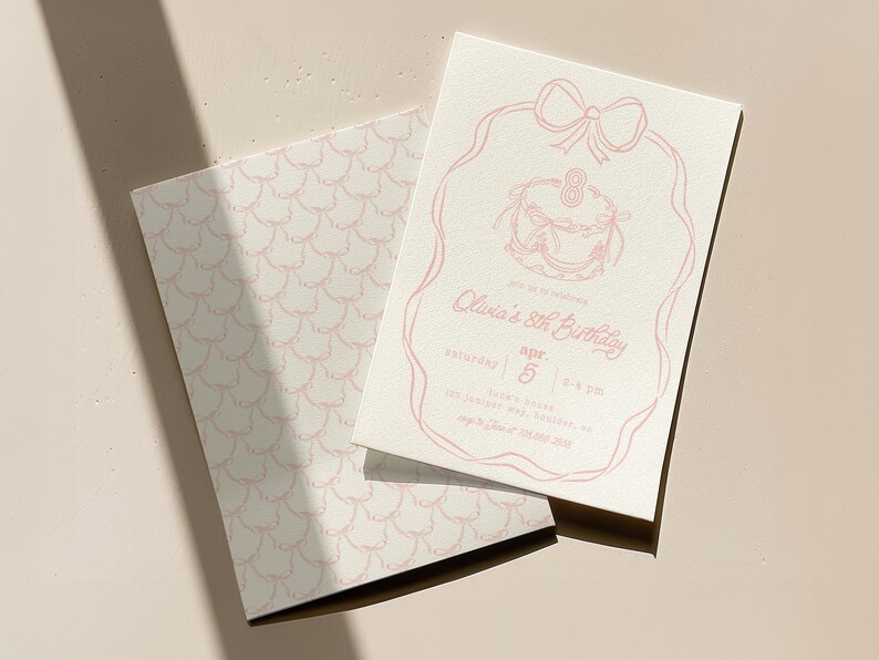 May include: Two-piece birthday invitation set. The invitation features a pink line drawing of a cake, bow, and text that reads "Olivia's 8th Birthday." The envelope has a pink scallop pattern.