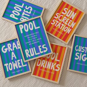 May include: A collection of six rectangular framed signs with light wood borders. The signs feature bold white text on backgrounds of vertical blue and green stripes or orange and yellow stripes, displaying pool-themed messages and instructions.