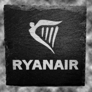 May include: Black and white image of a slate sign with the word "RYANAIR" in white letters and a white harp symbol above the text.