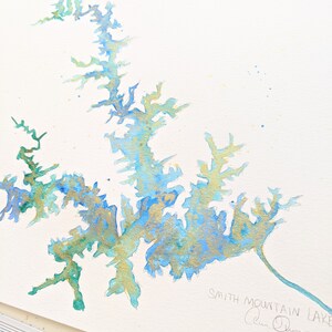 May include: Watercolor painting of Smith Mountain Lake in shades of blue, green, and gold. The painting is signed "Alan Olson" in the bottom right corner.
