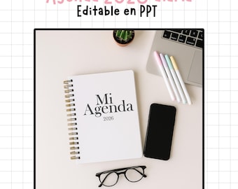 May include: A white spiral-bound notebook with the text "Mi Agenda 2026" sits on a white surface, next to a black smartphone, glasses, and a laptop. The image also includes pens and a small cactus. The text "Agenda 2026 diaria Editable en PPT" is at the top.