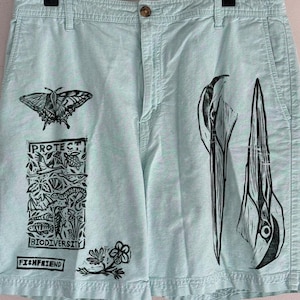 protect biodiversity great blue heron shorts  linocut print