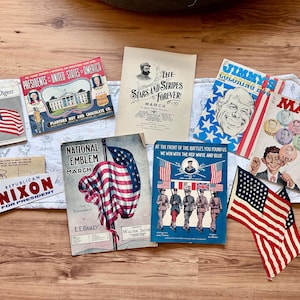 May include: A collection of vintage American memorabilia including a Reader's Digest, a Planters Nut and Chocolate Co. Presidents of the United States booklet, sheet music for Stars and Stripes Forever and National Emblem, a Mad magazine, and a Nixon bumper sticker.
