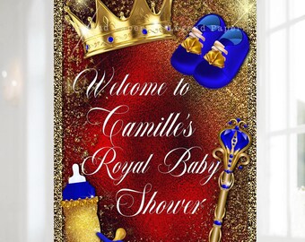 May include: A baby shower sign with a red and gold background. The sign features a gold crown, blue baby shoes, a baby bottle, and a scepter. The text reads "Welcome to Camille's Royal Baby Shower."