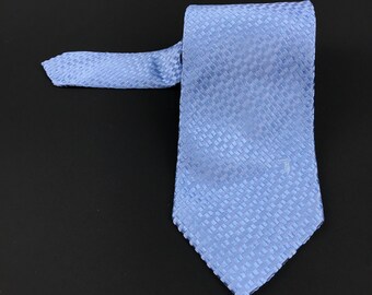 May include: A light blue patterned silk tie with a small white logo.