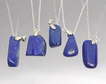May include: Five silver necklaces with blue lapis lazuli stone pendants of different shapes and sizes. The pendants are all attached to silver chains.