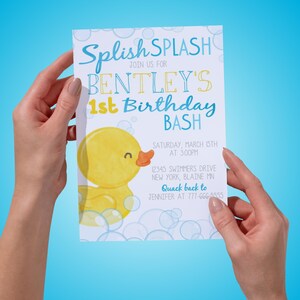 May include: A white rectangular birthday invitation card featuring a yellow rubber duck illustration, blue bubbles, and text that reads: Splish SPLASH JOIN US FOR BENTLEY'S 1st Birthday BASH SATURDAY, MARCH 15TH AT 3:00PM 12345 SWIMMERS DRIVE NEW YORK, BLAINE MN Quack back to JENNIFER AT 777-666-5555.