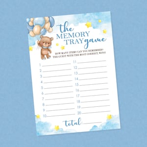 May include: A blue and white baby shower game card with a teddy bear holding balloons. The card has the text "The Memory Tray Game" and instructions for a memory game. The card has a blue watercolor background with yellow stars.