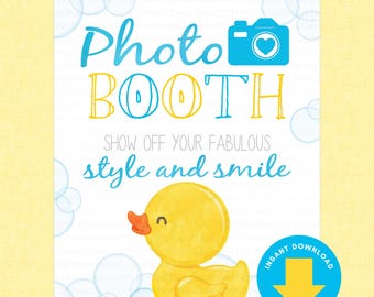May include: A white sign with light blue bubbles features the text Photo BOOTH in blue and yellow, a blue camera icon with a heart, and the text SHOW OFF YOUR FABULOUS style and smile. A yellow rubber duck is at the bottom with an instant download icon.