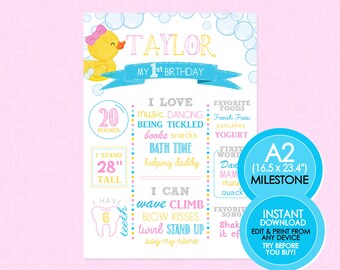May include: A pink and blue milestone poster for a first birthday with a yellow rubber ducky illustration. The poster includes the name "Taylor", the child's weight, height, and other milestones. The poster also includes the text "A2 (16.5 x 23.4") Milestone" and "Instant Download Edit & Print from any device Try before you buy!"