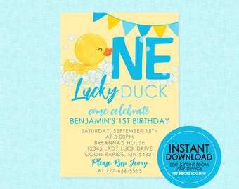 May include: A yellow and blue printable invitation for a first birthday party. The invitation features a cartoon rubber ducky with the number "ONE" in blue letters and the words "Lucky Duck" in a handwritten font. The invitation also includes the text "come celebrate Benjamin's 1st birthday" and details for the party, including the date, time, location, and RSVP information.