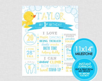 May include: A milestone poster for a first birthday, featuring a yellow rubber duck and blue bubbles. The poster includes the name "Taylor", the text "My 1st Birthday", and details such as weight (20 pounds) and height (28 inches).
