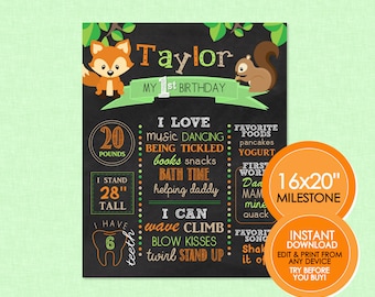 May include: A black chalkboard style 16x20 inch milestone poster with a green and orange color scheme. The poster features a fox and a squirrel illustration. The text on the poster reads "Taylor My 1st Birthday". The poster lists milestones such as weight, height, and favorite foods.