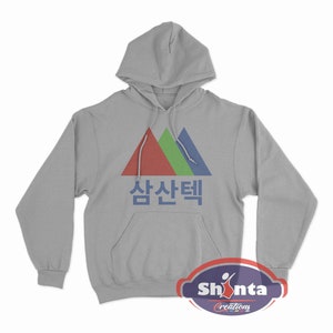May include: A gray hooded sweatshirt with a graphic of three colorful triangles and the Korean text "삼산택" in black.