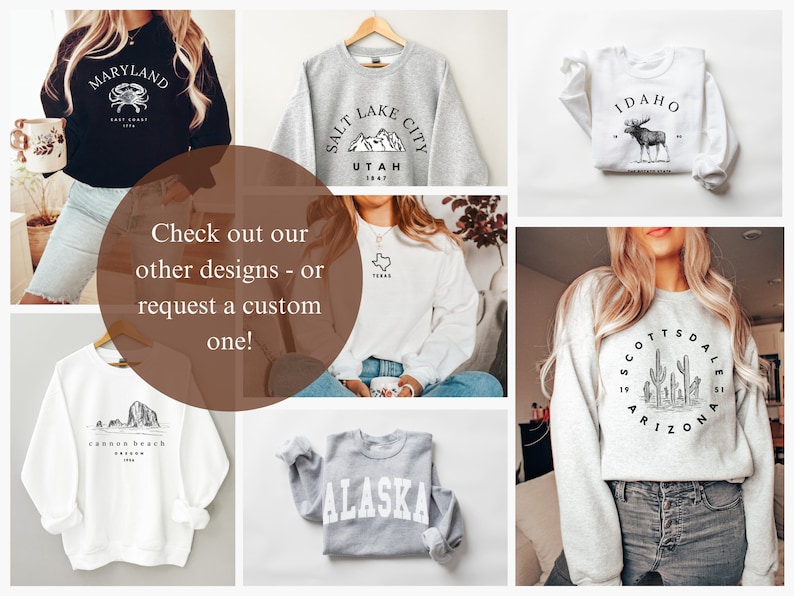 May include: A collage of images featuring various sweatshirts with state-themed designs. The sweatshirts are in different colors, including black, white, gray, and heather gray. The designs include a crab, mountains, a moose, cacti, and a mountain range. The text on the sweatshirts includes the names of states such as Maryland, Utah, Idaho, Arizona, and Alaska.