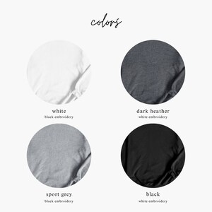 May include: Four fabric swatches showing different colour options for a t-shirt. The colours are white, dark heather, sport grey, and black. The text below each swatch indicates the colour and the embroidery colour option.