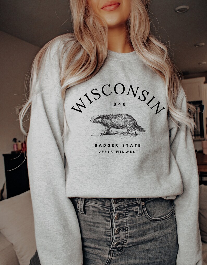 May include: Gray sweatshirt with a black graphic print of a badger and the text "WISCONSIN 1848 BADGER STATE UPPER MIDWEST".