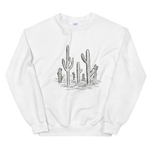 May include: White sweatshirt with a black and white line drawing of a group of cacti on the front.