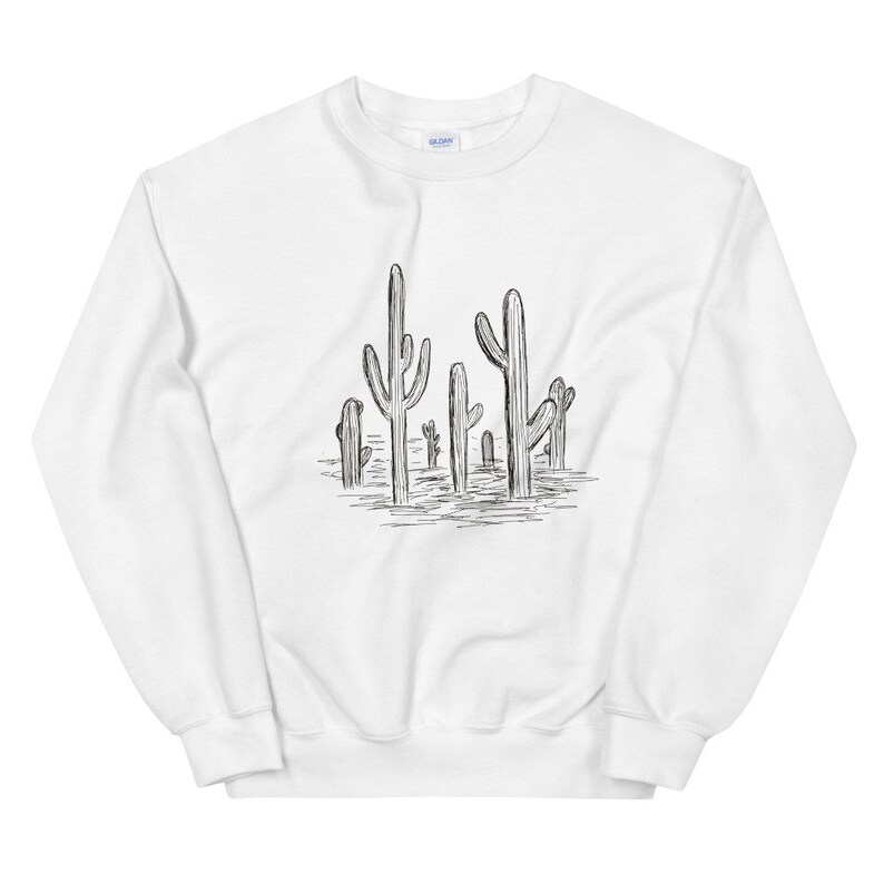 May include: White sweatshirt with a black and white line drawing of a group of cacti on the front.