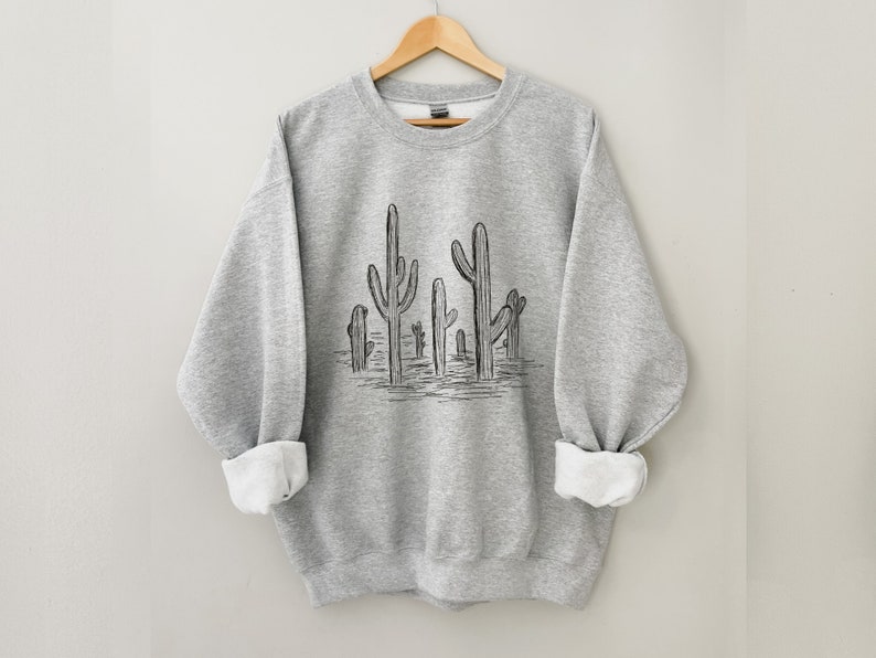 May include: A heather gray sweatshirt with a black line drawing of a group of cacti on the front.