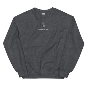 May include: A dark gray sweatshirt with a white outline of the state of Rhode Island and the text "Rhode Island" underneath.