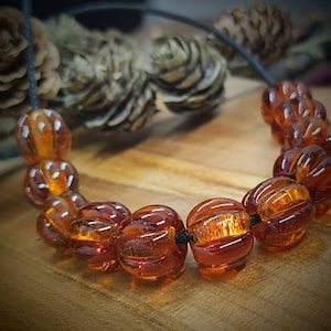 Bead set 10+1 Amber colored topaz-brown melon glass beads