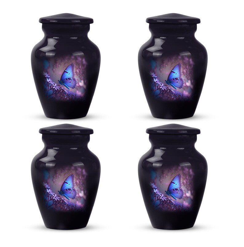 May include: Four small, dark purple, ceramic urns with lids. Each urn features a white butterfly with blue wings on a purple floral background.