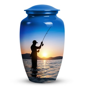 May include: Blue cremation urn with a sunset scene and a silhouette of a person fishing. The urn has a glossy finish.