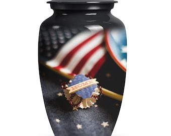 May include: A black metal urn with a patriotic design featuring an American flag, a blue heart with the word "HOME" on it, and red, white, and blue stars on a blue background.