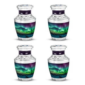 May include: Four silver-toned urns with a vibrant design of the aurora borealis. The urns feature a dark purple band and a detailed silver rim. The image on the urns depicts a colorful display of green and purple lights over a landscape.