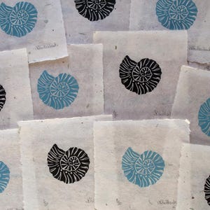 Mini Ammonite fossil linocut print in two colour ways, blue and black. Wall decor, art print